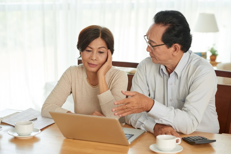 unhappy senior couple discussing their budget.