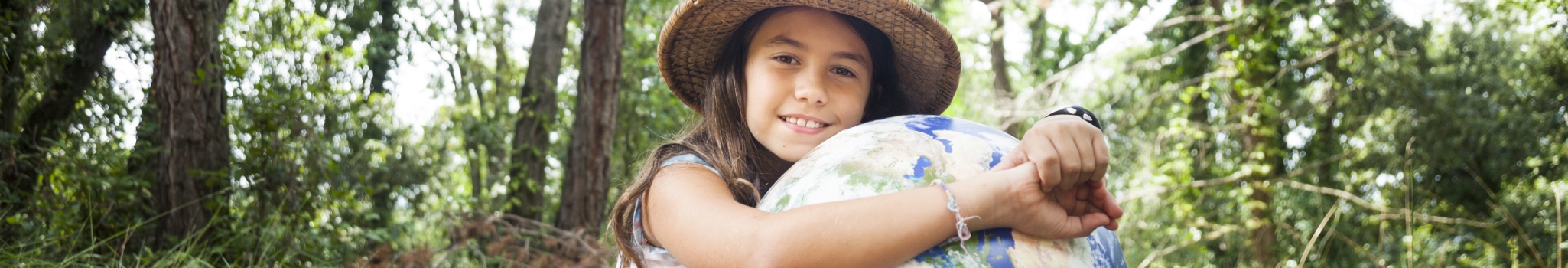 I love my planet: Young scout girl embracing world globe.